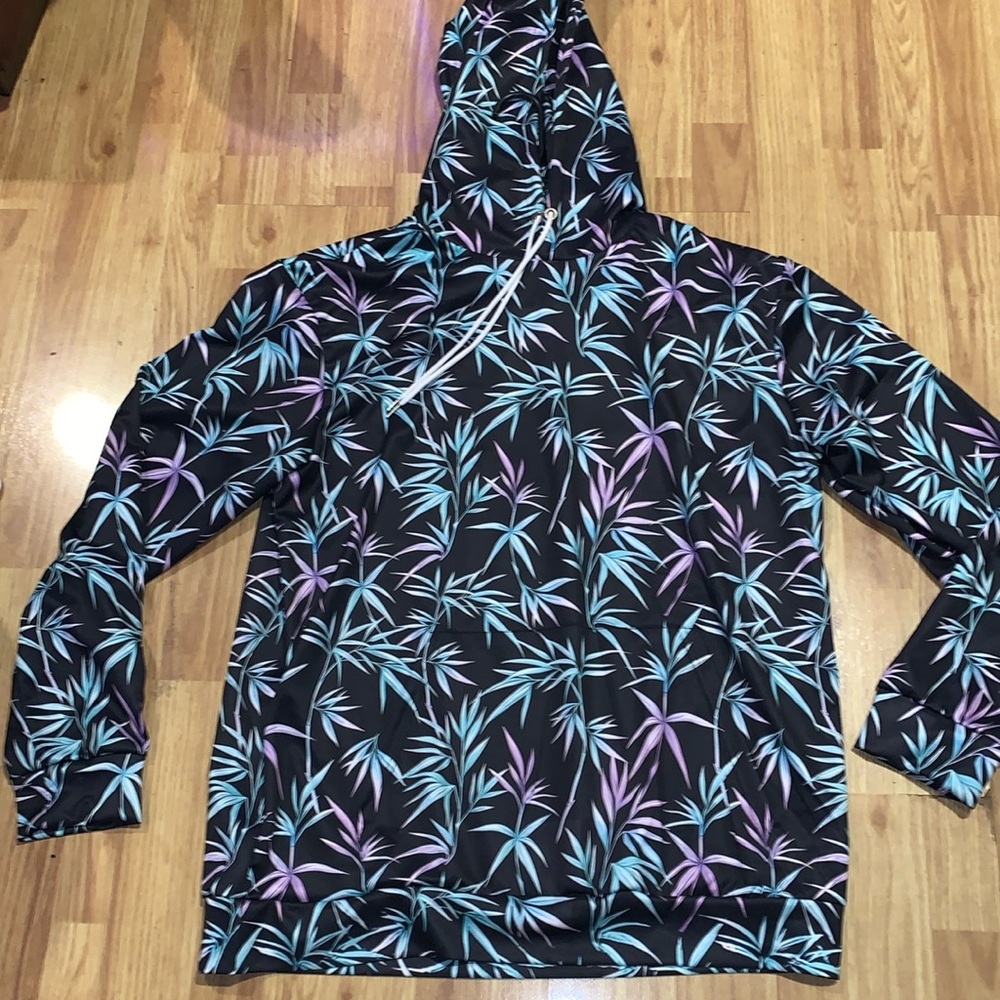 Silky decorative pullover. Green and purple leaves on black.